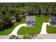 A beautiful home with fresh landscaping is nestled near a tranquil lake and lush green trees at 300 Mitnik Dr, Deltona, FL 32738