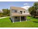 Backyard view showcasing spacious green lawn, covered patio, and balcony at 300 Mitnik Dr, Deltona, FL 32738