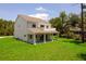Exterior view highlighting the home's backyard, green lawn, and deck at 300 Mitnik Dr, Deltona, FL 32738