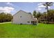Large backyard featuring a green lawn and white exterior of the home at 300 Mitnik Dr, Deltona, FL 32738