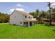 Backyard view featuring well-maintained lawn and white exterior of the home at 300 Mitnik Dr, Deltona, FL 32738