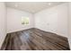 Empty bedroom with wood-look floors, base trim, bright white walls, recessed lights and natural light at 300 Mitnik Dr, Deltona, FL 32738