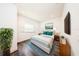 Stylishly staged bedroom with a comfy bed, dark wood floors, and bright natural light at 300 Mitnik Dr, Deltona, FL 32738