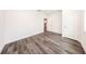 A freshly painted bedroom with light wood flooring, base trim, and two white doors at 300 Mitnik Dr, Deltona, FL 32738