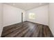 This spacious bedroom features wood-look floors, a large window, recessed lighting, and base trim at 300 Mitnik Dr, Deltona, FL 32738