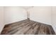 A pristine empty bedroom featuring wood-look flooring, base trim, and a bright white paint job at 300 Mitnik Dr, Deltona, FL 32738