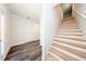 Bright foyer boasts wood staircase, gray flooring, and white trim at 300 Mitnik Dr, Deltona, FL 32738