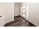 Modern foyer with beautiful dark laminate floors and a stylish front door with side windows at 300 Mitnik Dr, Deltona, FL 32738