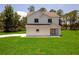 Two-story home with a well-manicured lawn and contemporary facade offers welcoming curb appeal at 300 Mitnik Dr, Deltona, FL 32738