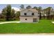 Charming two-story home with a well-manicured lawn provides a picture-perfect setting at 300 Mitnik Dr, Deltona, FL 32738