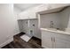 Functional laundry room with sink, white cabinets, and ample storage at 300 Mitnik Dr, Deltona, FL 32738