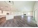 Spacious open-concept living area with sleek gray floors and modern finishes and plenty of natural light at 300 Mitnik Dr, Deltona, FL 32738
