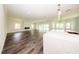 Open-concept living area with laminate flooring and a kitchen island next to the spacious living room at 300 Mitnik Dr, Deltona, FL 32738