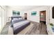 Comfortable main bedroom featuring hardwood floors, modern design and ensuite bathroom at 300 Mitnik Dr, Deltona, FL 32738