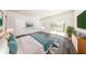 Sunlit main bedroom features hardwood floors, walk-out balcony and modern decor at 300 Mitnik Dr, Deltona, FL 32738