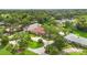 Stunning aerial view of home showcasing lush landscaping and circular driveway at 3215 Greens Ave, Orlando, FL 32804