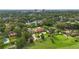 A high aerial shot showcases the home's location amidst lush greenery and mature trees in a well-maintained neighborhood at 3215 Greens Ave, Orlando, FL 32804
