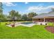 Expansive backyard with a sparkling pool, spa, patio, and lush green lawn at 3215 Greens Ave, Orlando, FL 32804