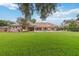 Spacious yard with a covered patio, pool, and lush green lawn, ideal for outdoor entertaining at 3215 Greens Ave, Orlando, FL 32804