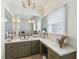 Bathroom with a decorative chandelier, vanity and an oversized mirror with plenty of counter space at 3215 Greens Ave, Orlando, FL 32804