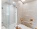 Detailed bathroom featuring a shower with glass door, a bathtub and cream tile at 3215 Greens Ave, Orlando, FL 32804