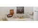 Bright bathroom featuring a soaking tub with gold fixtures and marble countertops with art decorations at 3215 Greens Ave, Orlando, FL 32804
