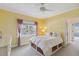 Bedroom with window, fan, neutral carpet, and under bed storage; ample sunlight streams into the space at 3215 Greens Ave, Orlando, FL 32804