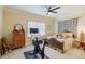 Bedroom with a ceiling fan and a queen bed, providing a peaceful and relaxing atmosphere at 3215 Greens Ave, Orlando, FL 32804