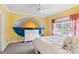 Bedroom featuring a mural, a ceiling fan, neutral carpet and curtains, and an abundance of natural light at 3215 Greens Ave, Orlando, FL 32804