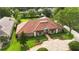 Elegant single-story home with lush landscaping, circular driveway, and a beautiful terracotta tile roof at 3215 Greens Ave, Orlando, FL 32804