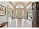 Elegant foyer with marble floors, chandelier, high ceilings, and a grand entry door with decorative glass at 3215 Greens Ave, Orlando, FL 32804