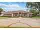 Stunning front exterior with circular driveway, lush landscaping, and inviting entrance with a tile roof and stone facade at 3215 Greens Ave, Orlando, FL 32804