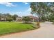 Expansive front lawn features manicured landscaping, a mature tree, and a circular driveway leading to the elegant home at 3215 Greens Ave, Orlando, FL 32804
