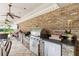 Covered outdoor grill station with stainless steel grill, refrigerator and stone accents at 3215 Greens Ave, Orlando, FL 32804