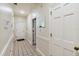 Hallway featuring tile flooring, white walls, and multiple doorways, highlighting the home's layout at 3215 Greens Ave, Orlando, FL 32804