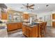 Bright kitchen features wood cabinets, granite counters, stainless steel appliances, and tile flooring at 3215 Greens Ave, Orlando, FL 32804