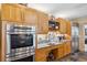 Contemporary kitchen features stainless steel appliances, wood cabinets, and granite countertops at 3215 Greens Ave, Orlando, FL 32804