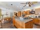 Spacious kitchen boasts wood cabinets, granite countertops, and a large central island at 3215 Greens Ave, Orlando, FL 32804