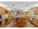 Spacious kitchen with wood cabinets, an island with seating, and stainless steel appliances at 3215 Greens Ave, Orlando, FL 32804