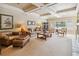 Spacious living room with coffered ceilings, comfortable seating, and ample natural light at 3215 Greens Ave, Orlando, FL 32804
