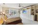 Large primary bedroom with built in cabinetry, ceiling fan and a view of the backyard at 3215 Greens Ave, Orlando, FL 32804