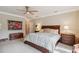 Primary bedroom featuring a ceiling fan, a bed, and bedside tables with lamps at 3215 Greens Ave, Orlando, FL 32804