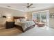 Large primary bedroom featuring a ceiling fan, bay window and view of the backyard and pool at 3215 Greens Ave, Orlando, FL 32804