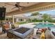 Covered outdoor seating area with fire pit, with a view of the backyard and pool at 3215 Greens Ave, Orlando, FL 32804