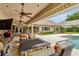 Relax on your lanai, that includes outdoor seating, a fire pit and a view of a manicured backyard with a pool at 3215 Greens Ave, Orlando, FL 32804
