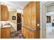 Butler's pantry with custom cabinetry, wine refrigerator, and granite countertops at 3215 Greens Ave, Orlando, FL 32804