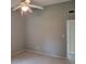 Bedroom featuring carpet, ceiling fan and grey walls with white trim, offering neutral tones at 3305 Robinson St, Zellwood, FL 32798