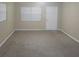 Spacious bedroom with carpet, window, and a closet with a door and white trim at 3305 Robinson St, Zellwood, FL 32798
