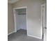 Bedroom features a closet with a bar for hanging clothes and neutral colors throughout at 3305 Robinson St, Zellwood, FL 32798