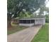 Charming single story home featuring a screened in porch and a long driveway at 3305 Robinson St, Zellwood, FL 32798